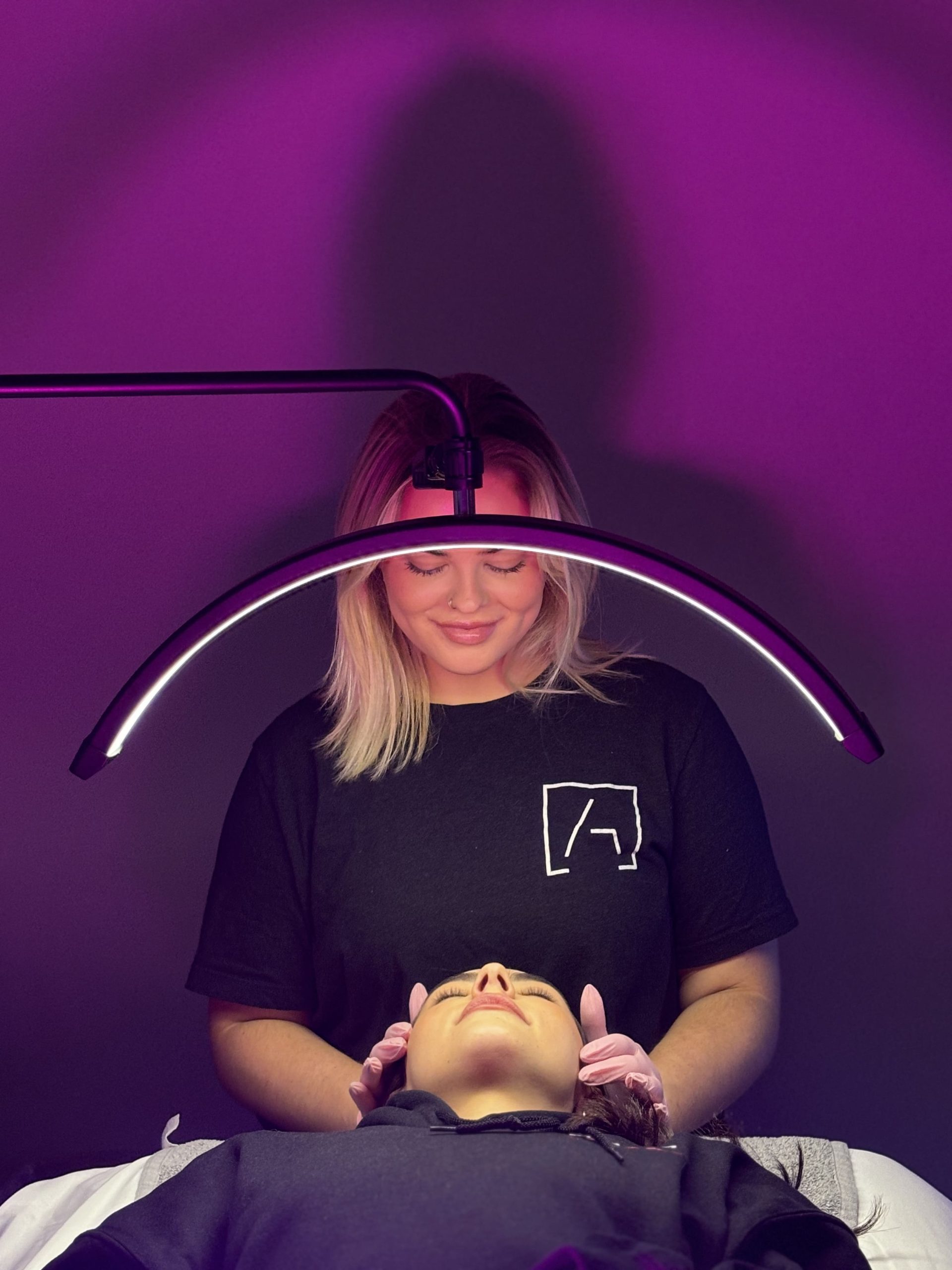 Client receiving a customized HydraFacial treatment from an AALC aesthetician